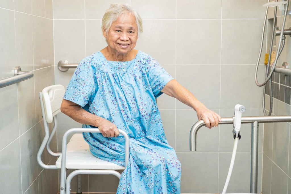 Asian elderly woman patient use toilet bathroom handle security in nursing hospital, healthy strong medical concept.