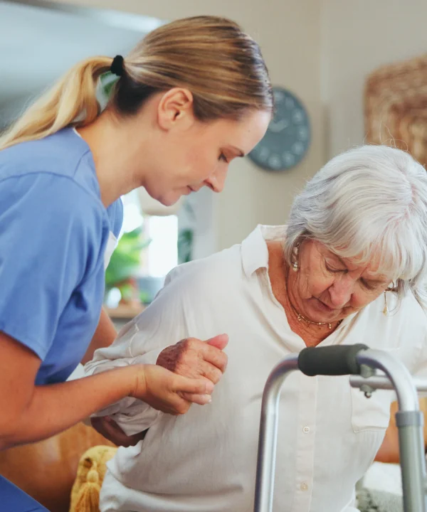 Nurse assisting elder woman