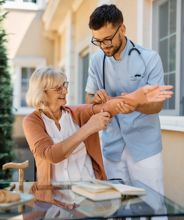 Nurse checking elder woman hand