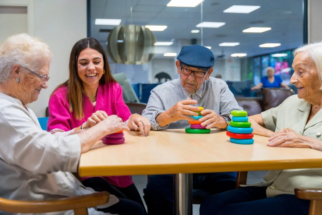 Nurse helping a elder woman playing skill games