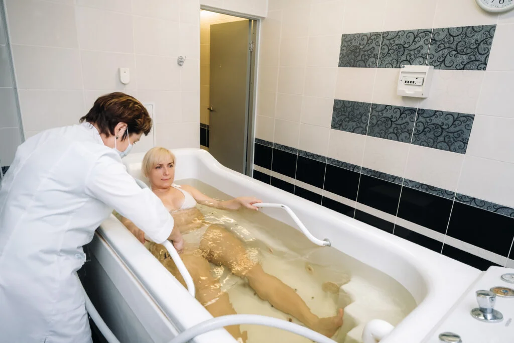 the procedure of underwater shower massage in the bathroom.Girl on the procedure of underwater massage